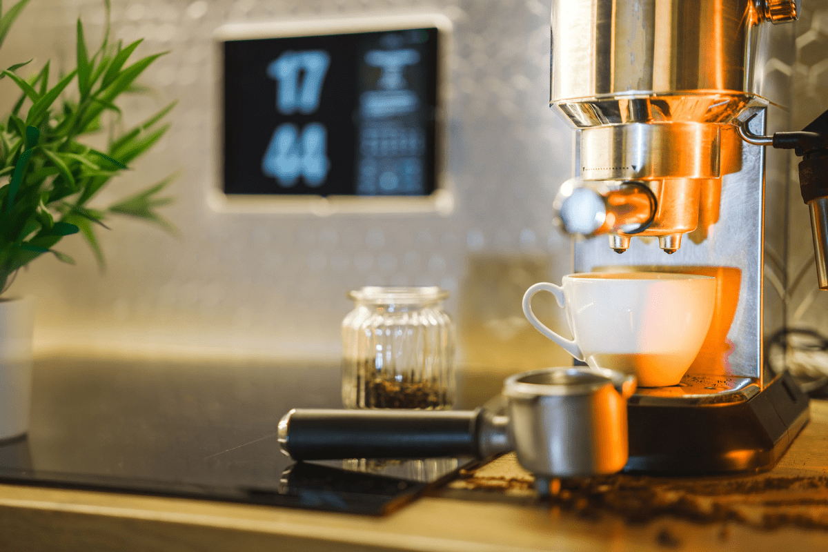 espresso machine on counter top with warm lighting and portafilter on counter