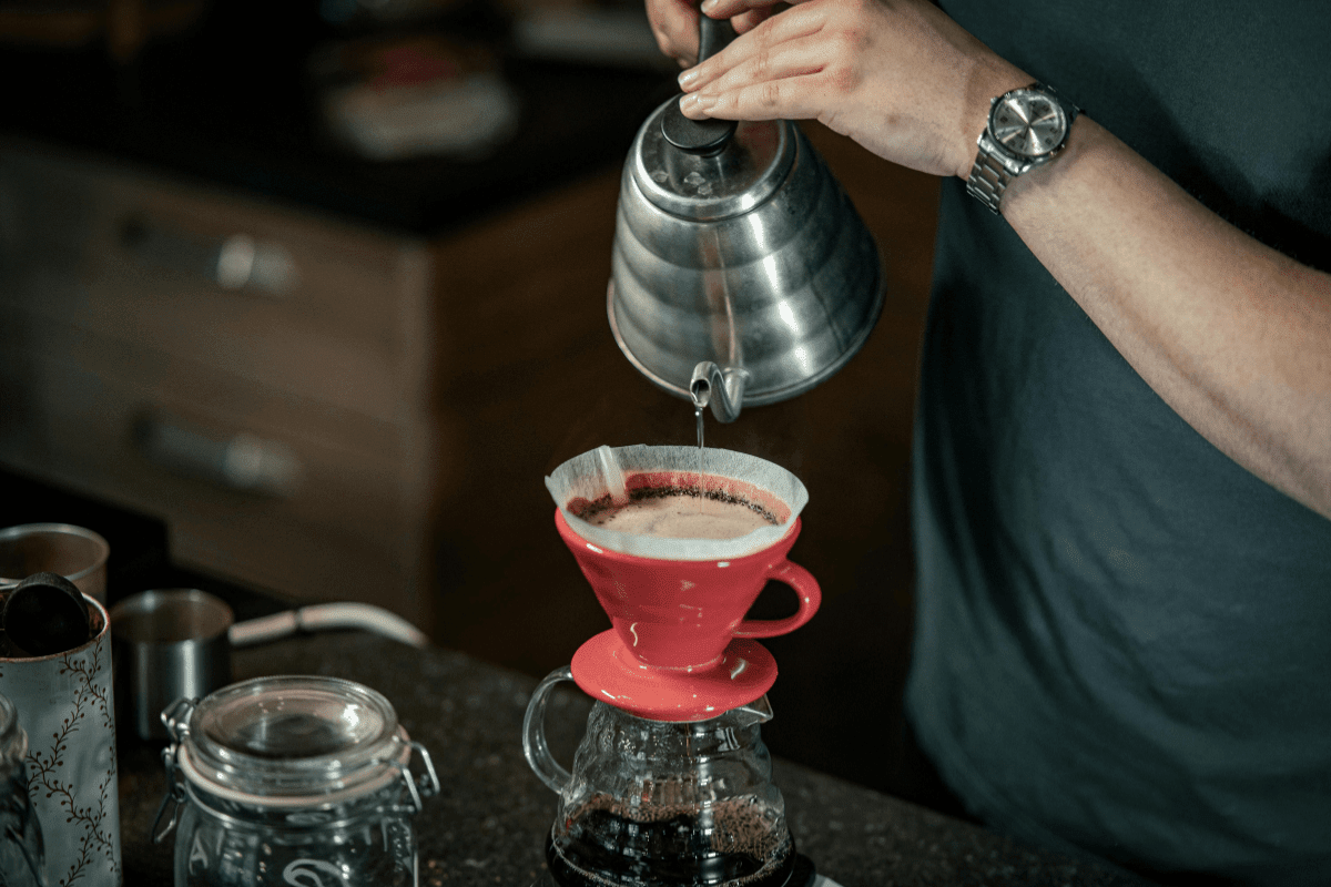 kettle pouring coffee into a dripper showing a pour over coffee prep