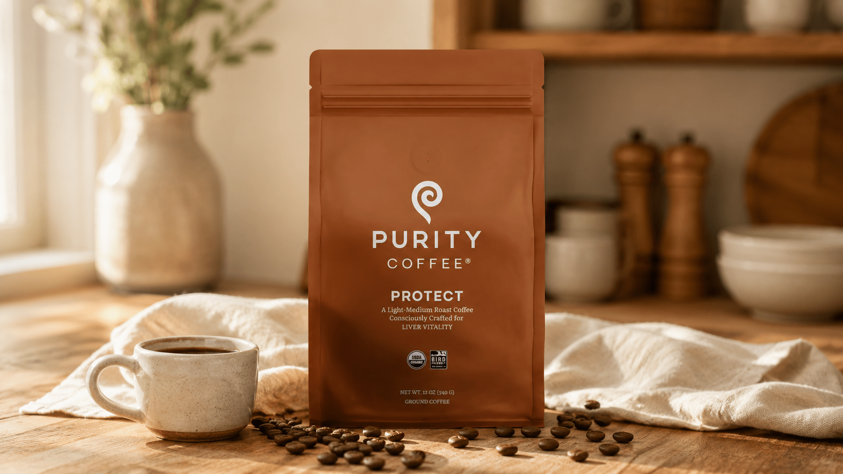 Purity Coffee organic specialty coffee bag styled on a warm wood surface with ceramic cup and scattered coffee beans